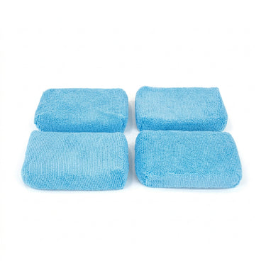 Four rectangular blue microfiber thin sponge on a white background