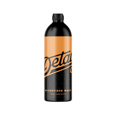 A 32oz black bottle of detail co. Microfiber with orange color design on top.