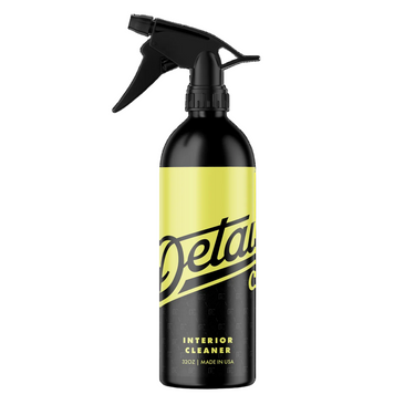 A black plastic 32 oz spray bottle of Detail co. interior cleaner on a clean white background,