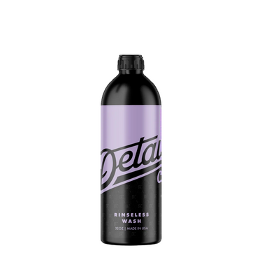 A 32oz bottle of Detailer Rinseless Wash on a solid white background. The bottle is black with a lavender-purple label band and black branding text.