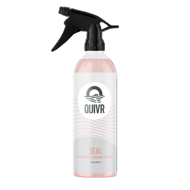 A 32oz spray bottle of Quivr Seal Universal Ceramic Sealant. The bottle is made of frosted translucent plastic showing a pale pink liquid inside, with a white label and a black trigger spray nozzle.