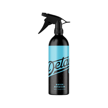 A black 32 oz spray bottle of detail co. Quick detailer with blue design on a white background.