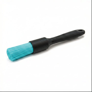 Black brush with teal stiff bristles on a white background