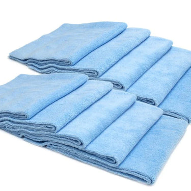 Set of folded blue towels on a white background