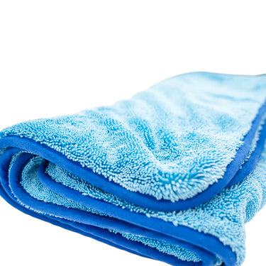 Folded blue microfiber towel on a white background
