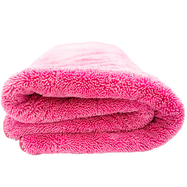 Folded pink towel on a white background